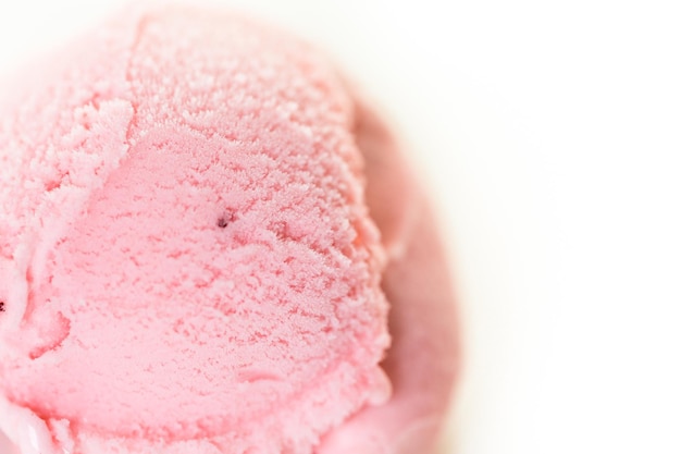 Boule de crème glacée aux fraises sur fond blanc.