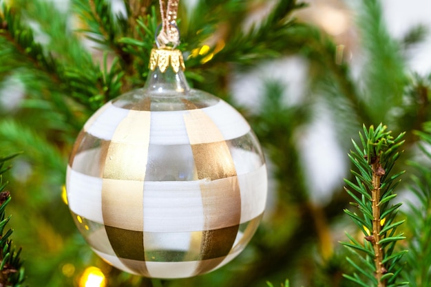 Boule de verre à rayures sur l'arbre de Noël libre