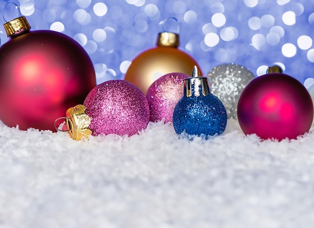 Boules de Noël ou décorations sur une neige sur un fond d'hiver lumineux