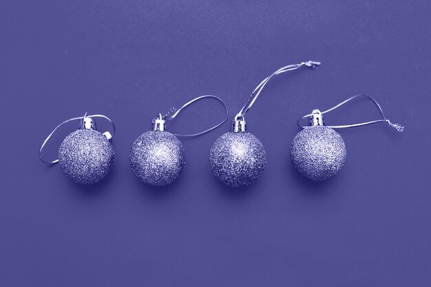 Boules de Noël dorées sur fond bleu. Très couleur Peri de l'année.