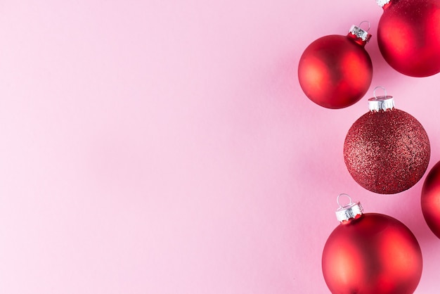 Boules de Noël rouges sur fond rose Noël et nouvel an