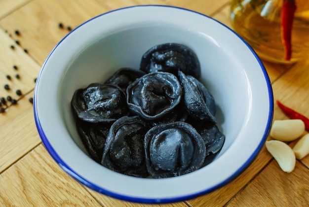 boulettes noires dans une assiette blanche sur la table