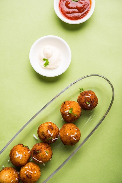 Boulettes de pommes de terre frites ou croquettes au ketchup aux tomates. Mise au point sélective