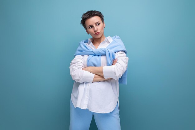 Bouleversé pensive young darkhaired woman with a short haircut in a white shirt