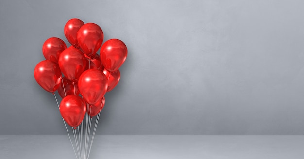 Bouquet de ballons rouges sur un mur gris