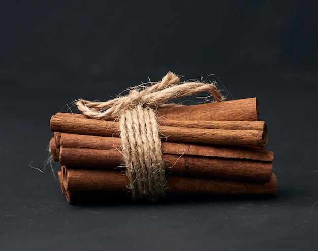 Bouquet de bâtons de cannelle brun sur un fond sombre