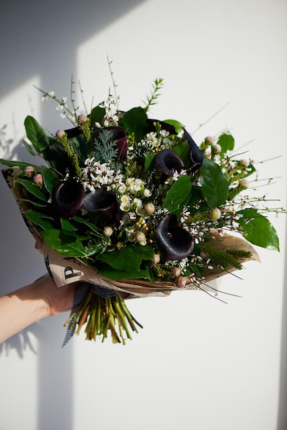 Un bouquet de cal noble foncé avec une fleur givrée Floral