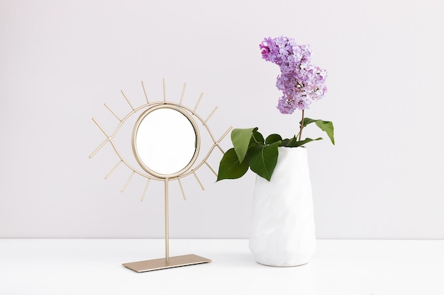 Bouquet de lilas dans un vase en verre isolé sur une branche blanche avec des fleurs de lilas