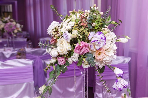 Un bouquet de mariage est posé sur la table au fond de la salle. Bouquet de la mariée.