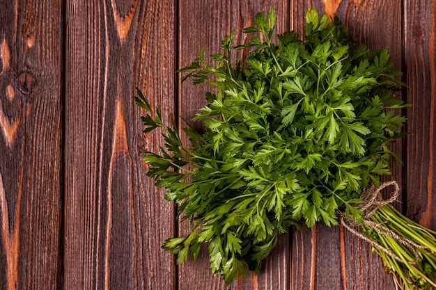 Bouquet de persil sur une table en bois.