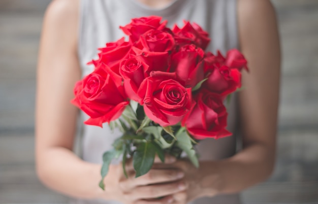 bouquet de roses rouges dans les mains