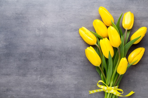 Bouquet de tulipes jaunes sur table grise