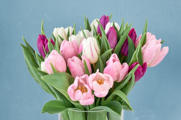 Bouquet de tulipes roses et blanches dans un vase en verre