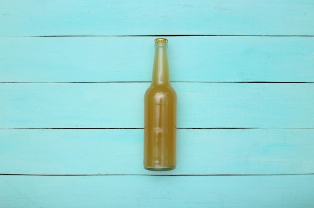 Bouteille de bière légère sur fond de bois bleu. Vue de dessus.