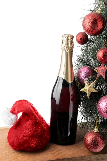 La bouteille de champagne avec bonnet de Noel et sapin de Noël