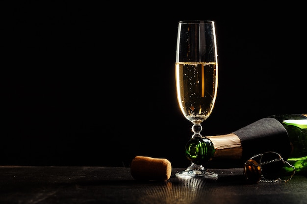 Bouteille de champagne et verres sur noir