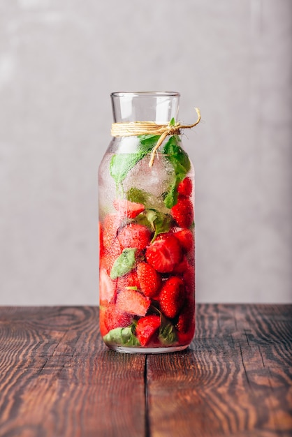 Bouteille D'eau Aromatisée Avec Des Feuilles De Fraise Fraîche Et De Basilic