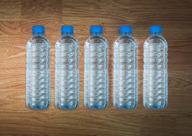 Bouteille d&#39;eau en plastique sur la table en bois