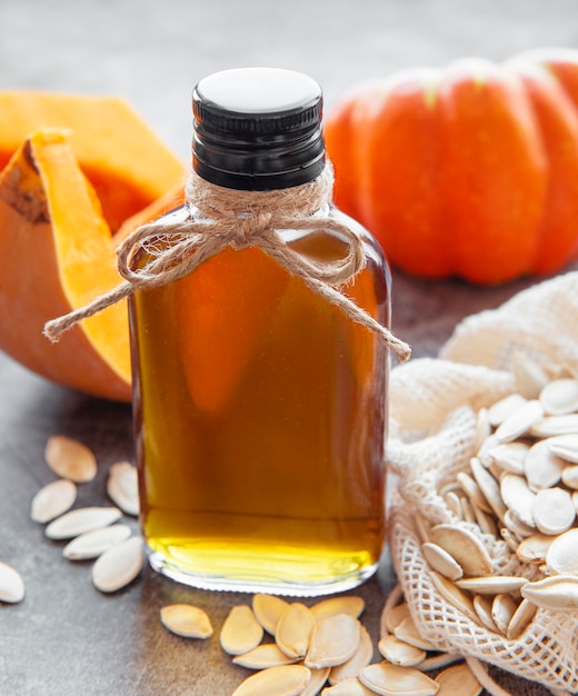 Bouteille d'huile de pépins de citrouille sur fond de béton gris