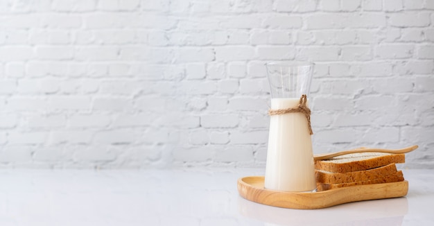 Bouteille de lait et pains tranchés sur la table de la cuisine.