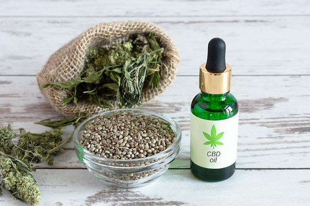 Bouteilles d'huile de chanvre avec graines de cannabis et feuilles sèches Huile de CBD médicale Médecine alternative