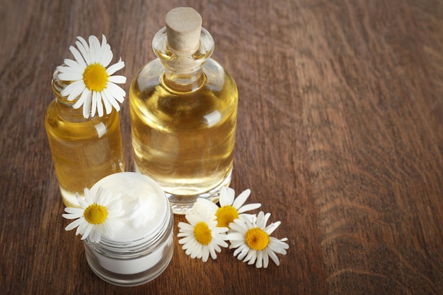 Bouteilles d'huile essentielle et de crème sur table