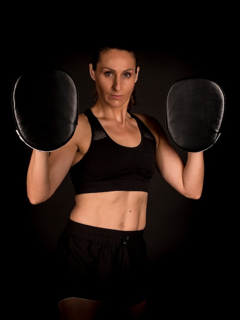 Boxe de formation de femme avec des mitaines