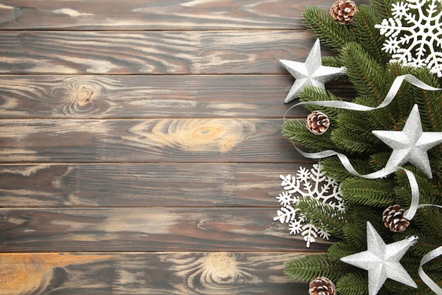 Branches de sapin avec décoration de Noël en argent sur fond marron