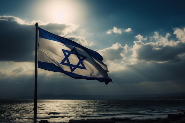 Brandir le drapeau d'Israël sur un mât avec la mer en arrière-plan