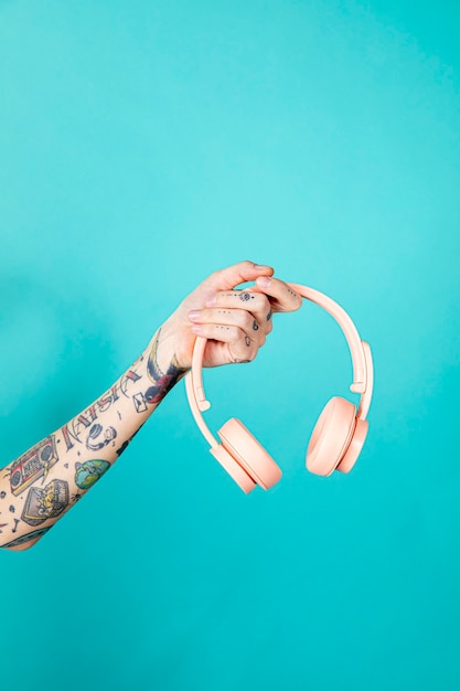 Bras tatoué tenant un casque rose