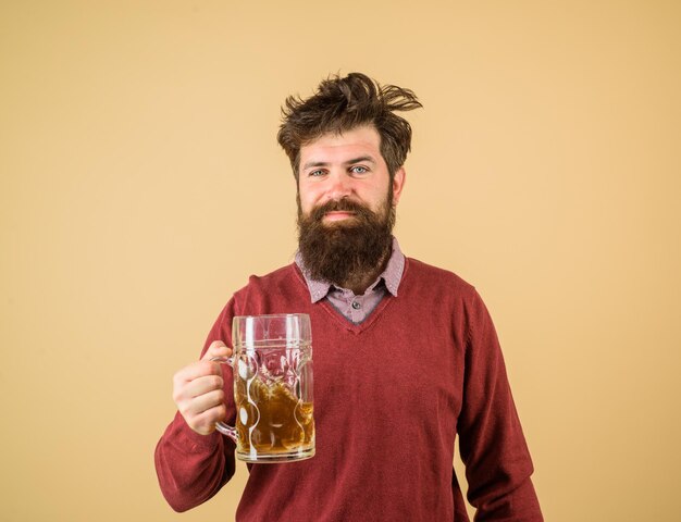 Un brasseur heureux Un brasseur masculin heureux tient du verre avec une dégustation de bière Le brasseur de bière fraîchement brassée tient du verre