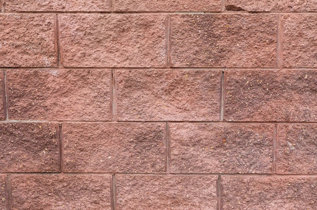 Brique rouge grunge sur la surface du mur du bâtiment, gros plan de carreaux décoratifs