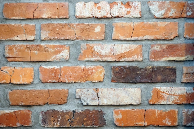 Briques fissurées vintage avec des lettres sur un mur