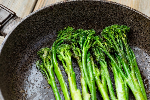 Broccolini frais avec de la poudre de noix cuite au four en gros plan