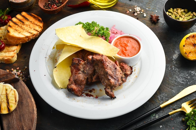 Brochettes de porc juteuses avec oignons et pain pita sur une assiette Vue de dessus