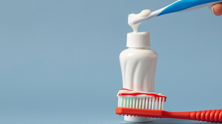 Photo une brosse à dents avec un dentifrice bleu et blanc dessus
