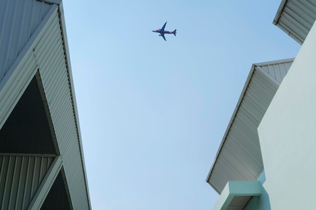 Bureau d'affaires avec ciel bleu Bâtiment d'entreprise en ville L'avion vole dans le ciel