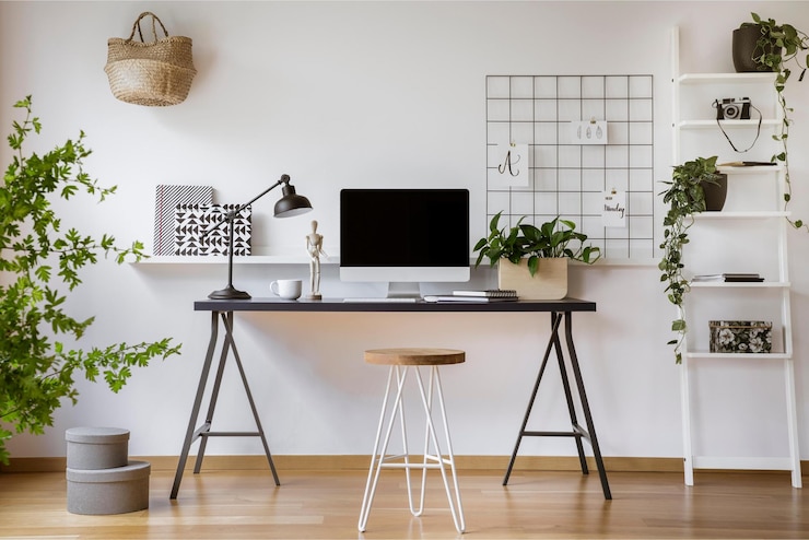 Photo un bureau à domicile avec un bureau et une plante au mur