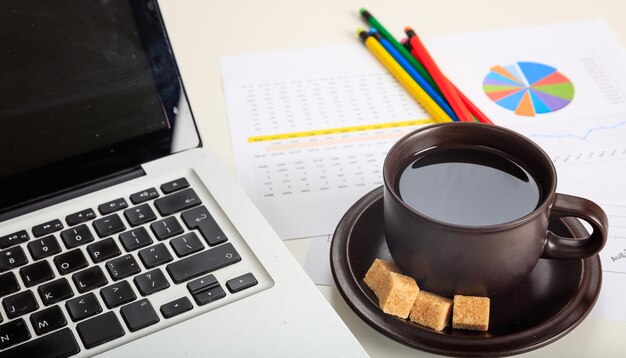 Bureau avec ordinateur portable et une tasse de café