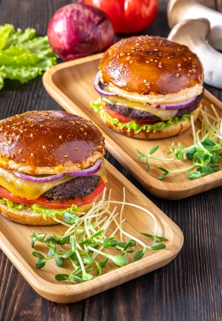 Burgers sur les assiettes en bois