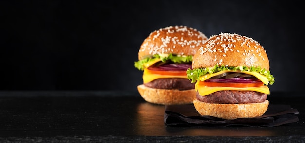 Burgers hamburgers cheeseburgers sur fond noir