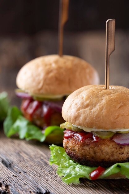 Burgers juteux frais sur une vieille table en bois