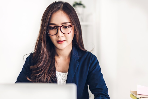 Businesswoman sitting and working with laptop computer.creative business people planning in her workstation at modern work loft