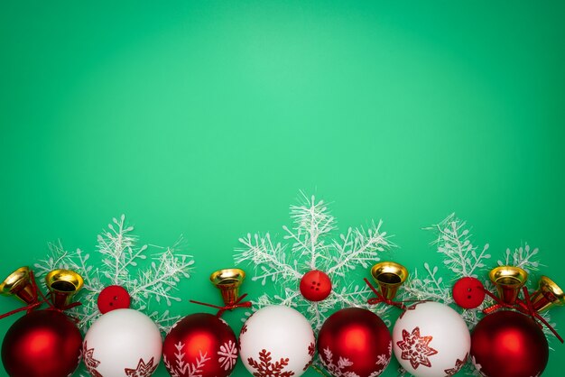 Cadeau de Noël, cloche et boule sur fond vert. Lay plat, vue de dessus