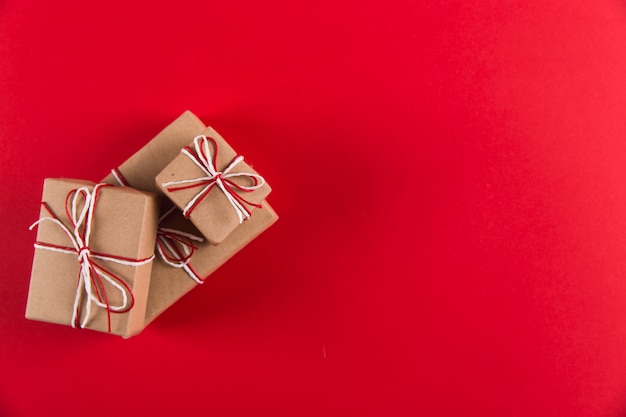 Cadeau de papier kraft et des cordes sur un fond rouge, Noël,
