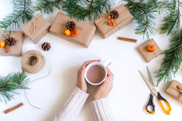 Cadeaux de Noël fille mains et chocolat chaud