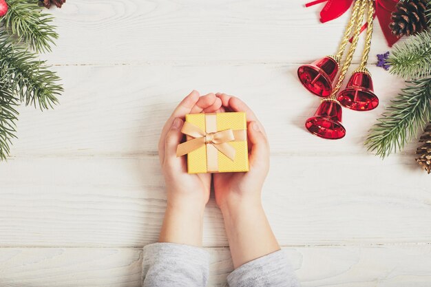 Cadeaux de Noël avec ruban jaune sur fond de bois blanc dans un style vintage