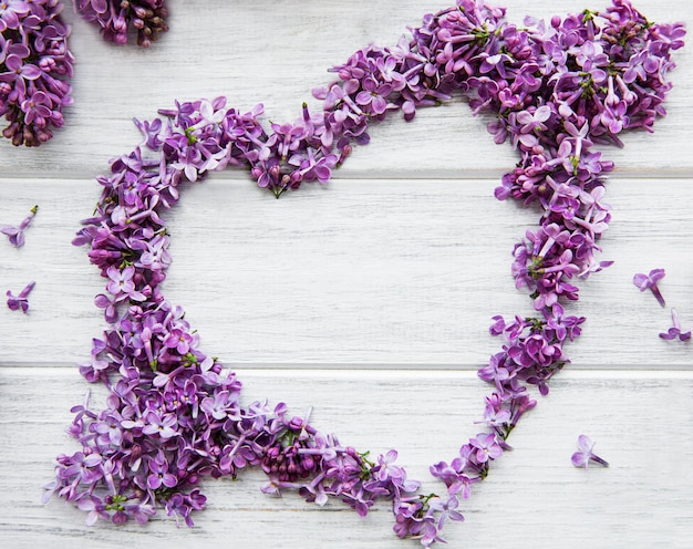 Cadre de branches et de fleurs de lilas en forme de coeur