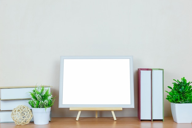 cadre photo blanc sur table en bois.