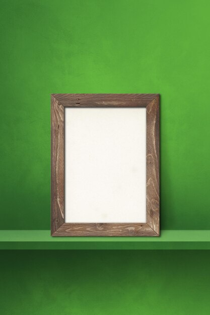 Photo cadre photo en bois s'appuyant sur une étagère verte illustration 3d modèle de maquette vierge fond vertical